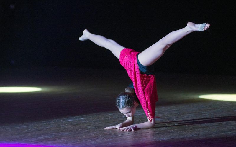 Man in a dynamic pose, showing controlled movement and strength.